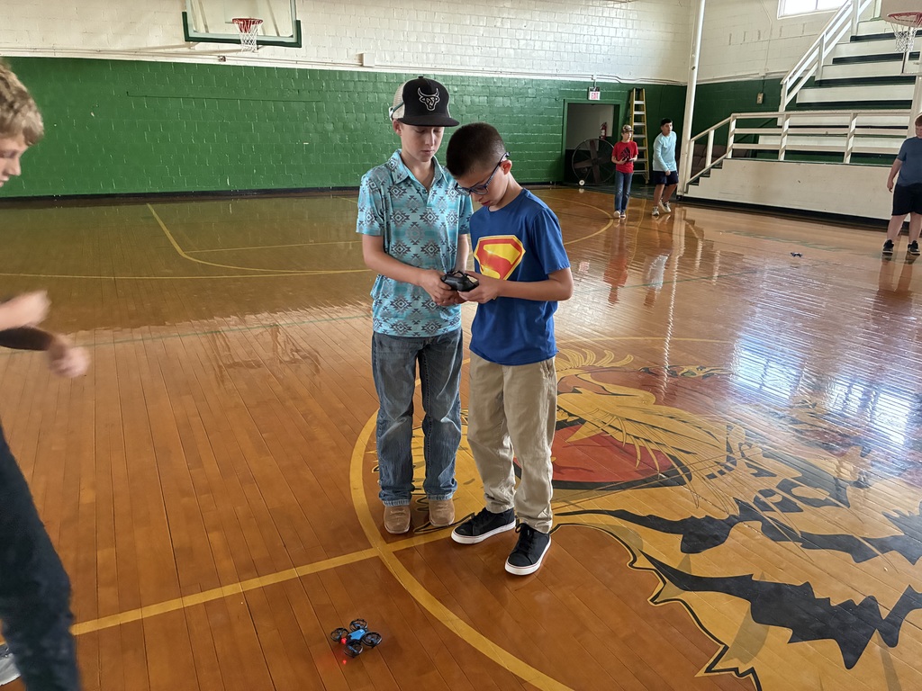 Sixth Grade STEM Class learning how to operate drones.