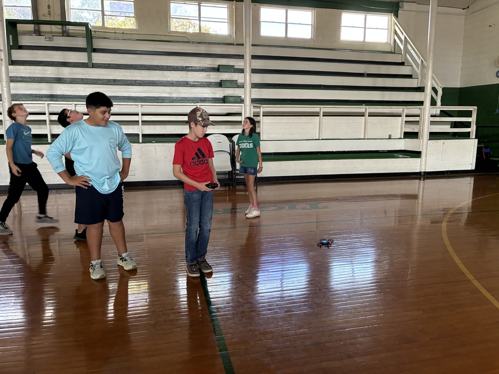 Sixth Grade STEM Class learning how to operate drones.