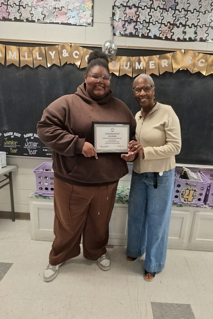 The image shows student Asia Stubs standing next to Maria Hoskins with the YARN organization.