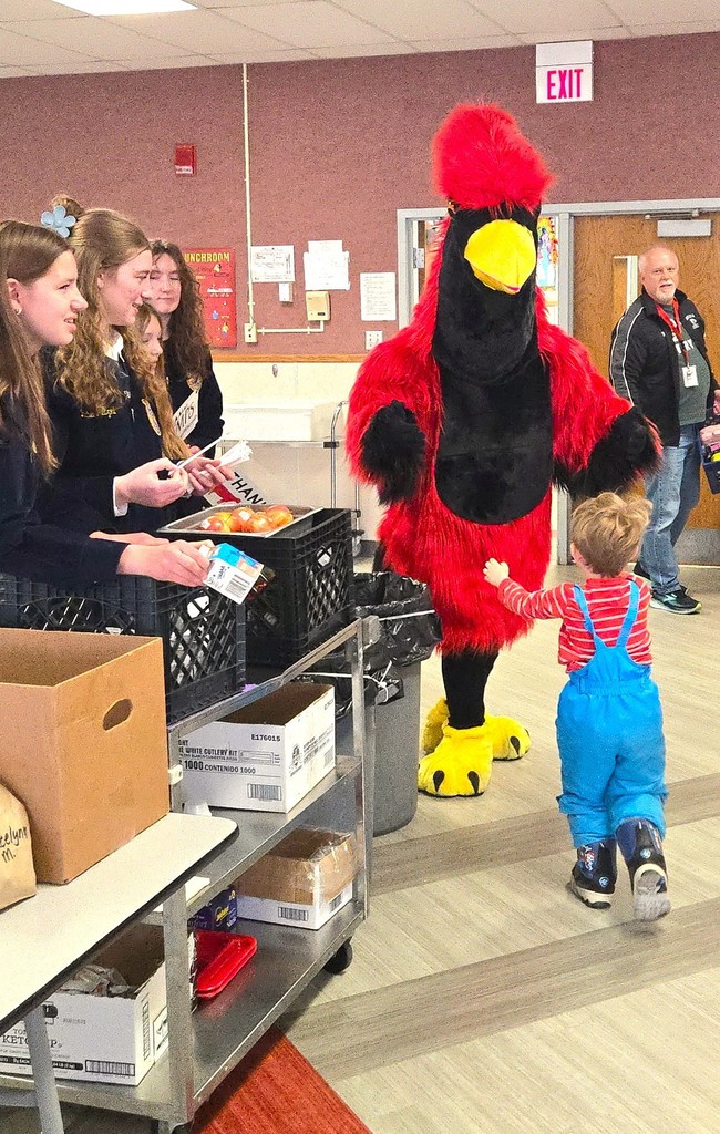 FFA milk handout courtesy of Kemps with Big Red (cardinal mascot) hugging our 4K learners