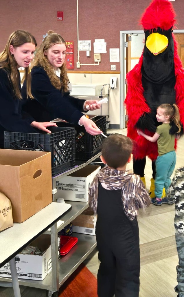 FFA milk handout courtesy of Kemps with Big Red (cardinal mascot) hugging our 4K learners