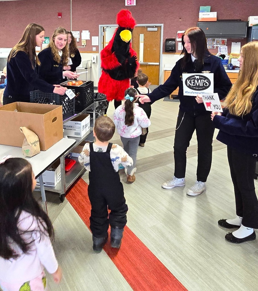 FFA milk handout courtesy of Kemps with Big Red (cardinal mascot) hugging our 4K learners
