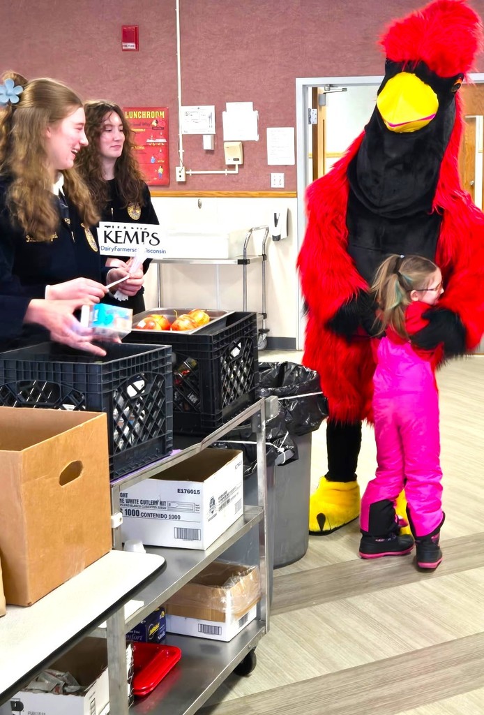 FFA milk handout courtesy of Kemps with Big Red (cardinal mascot) hugging our 4K learners
