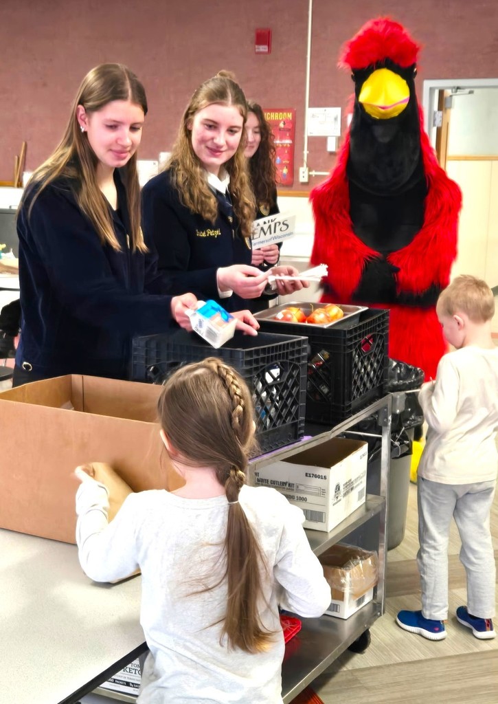 FFA milk handout courtesy of Kemps with Big Red (cardinal mascot) hugging our 4K learners
