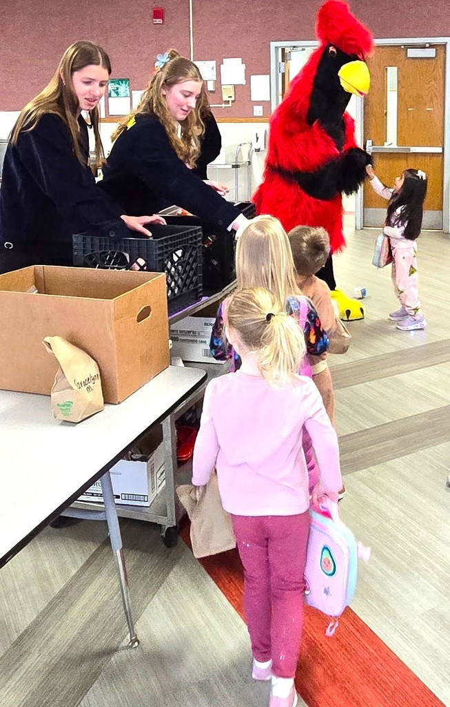 FFA milk handout courtesy of Kemps with Big Red (cardinal mascot) hugging our 4K learners