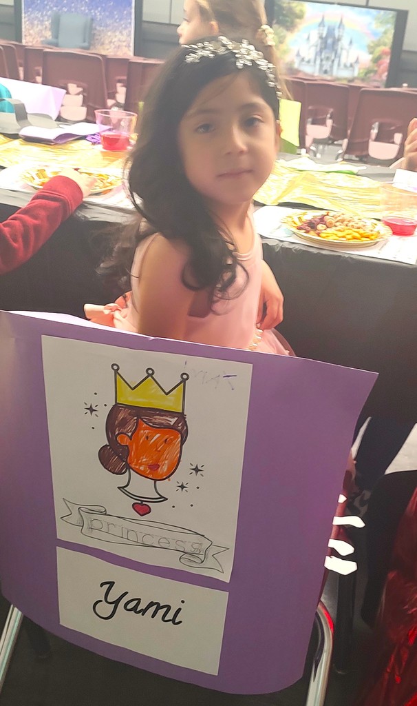 child at banquet table with royal snacks