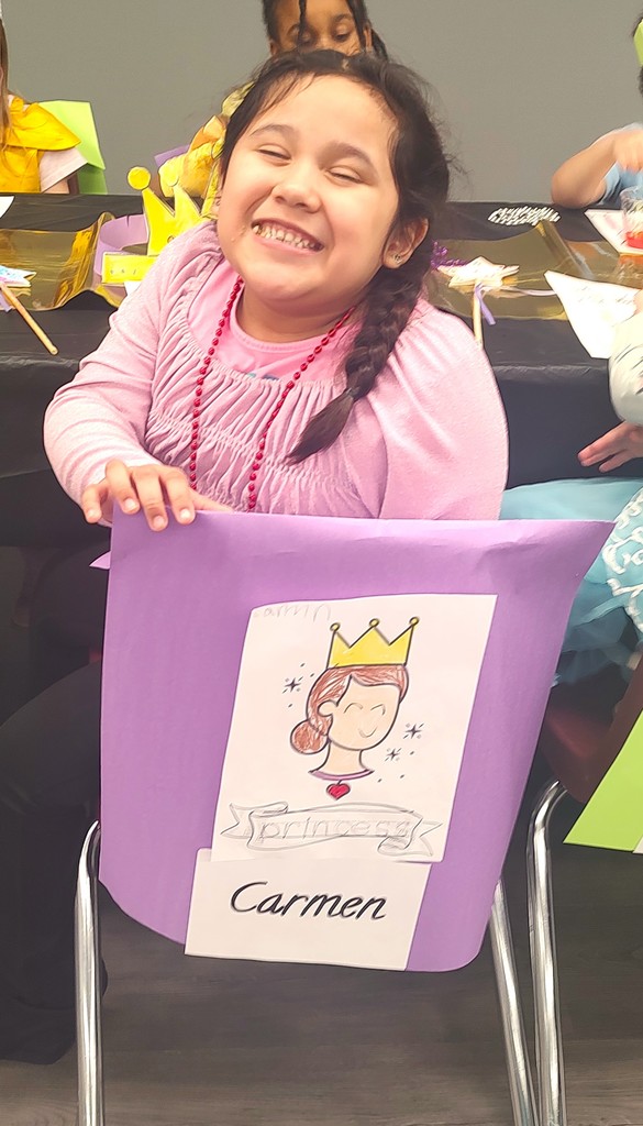 child smiling at banquet table