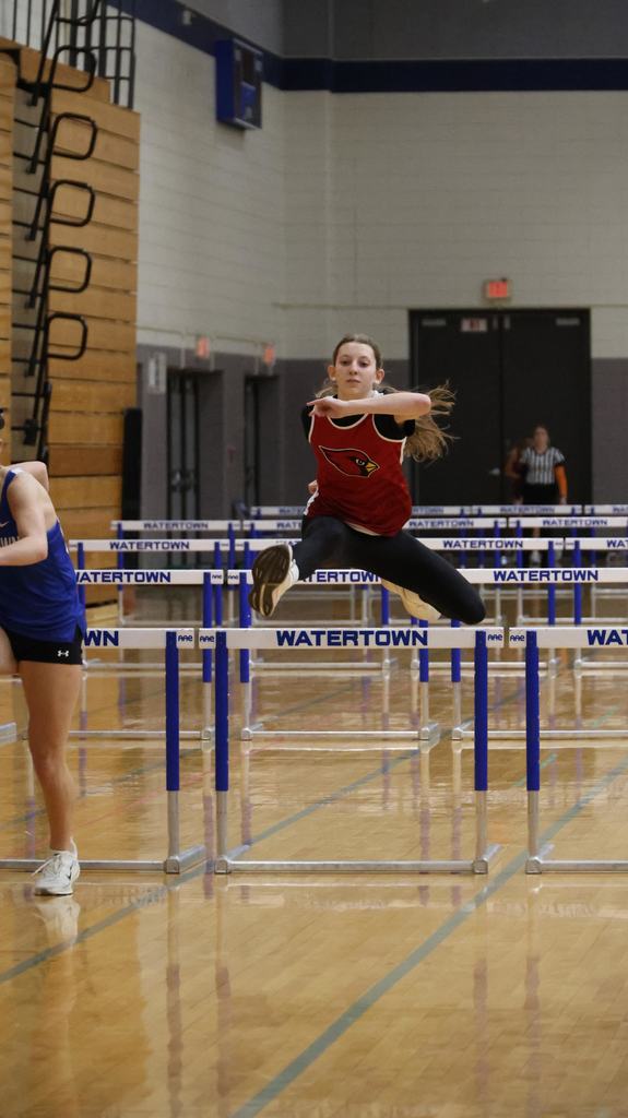 Watertown Indoor Track Meet in Watertown gym with Mayville Cardinal competitors running, relays, hurdles and high jump