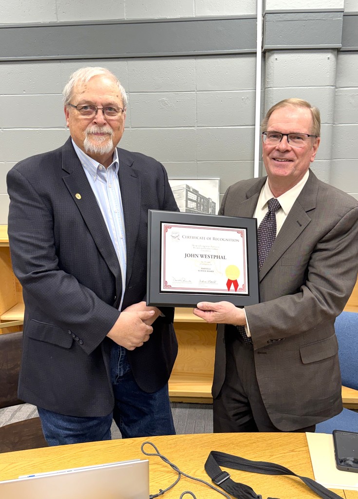 John Westphal Board Member recognition for 30 years of service, Mr. Westphal holding plaque in Board Administration Room within the Early Learning Center at Parkview, surrounded by fellow Board members, his family and presented the plaque by Dan Rossmiller, Executive Director of WASB