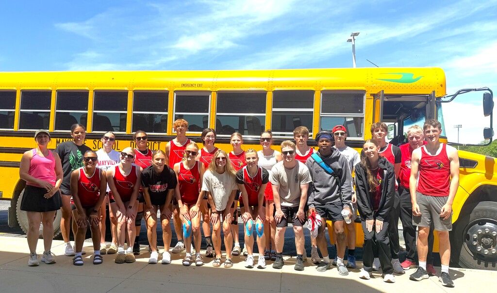 Mayville High School Track team sectional qualifiers smiling in front of school bus