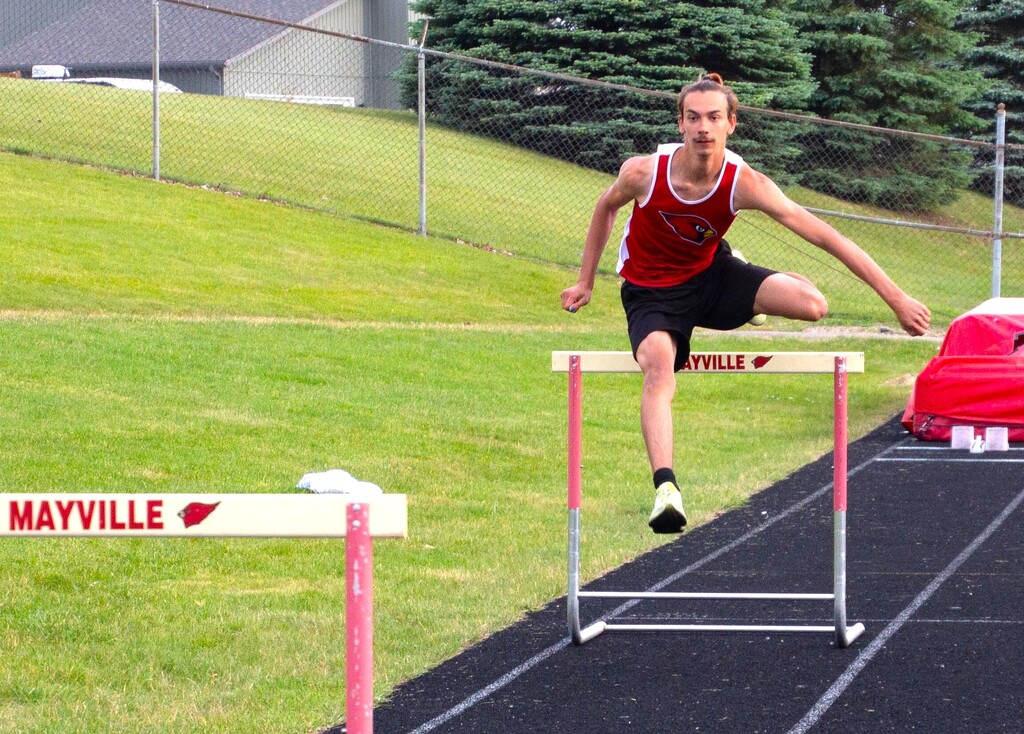 Mac L. state qualifier in Mayville Track uniform on MHS track practicing hurdles for State meet