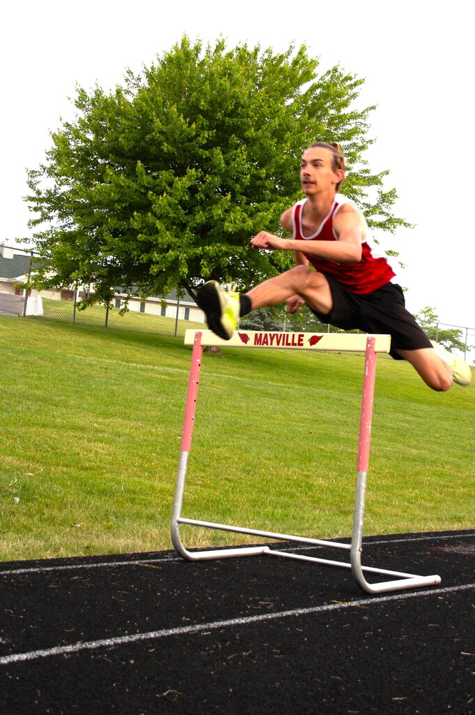 Mac L. state qualifier in Mayville Track uniform on MHS track practicing hurdles for State meet