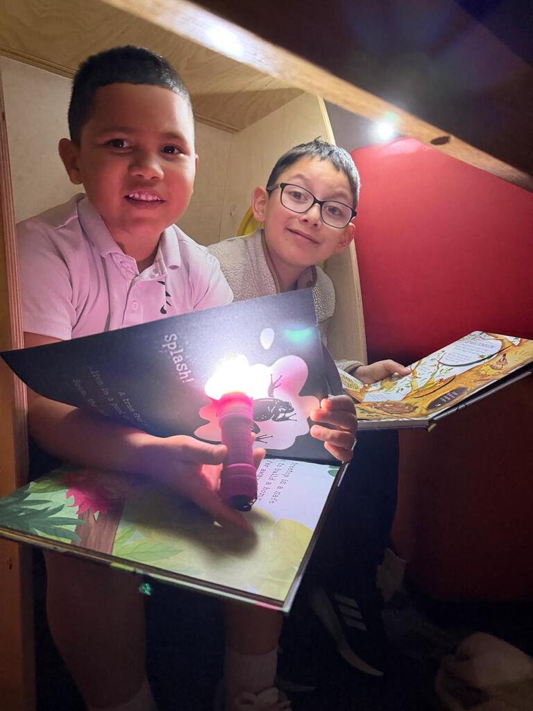 Children reading and smiling, creating reading nooks, tents and homemade lanterns