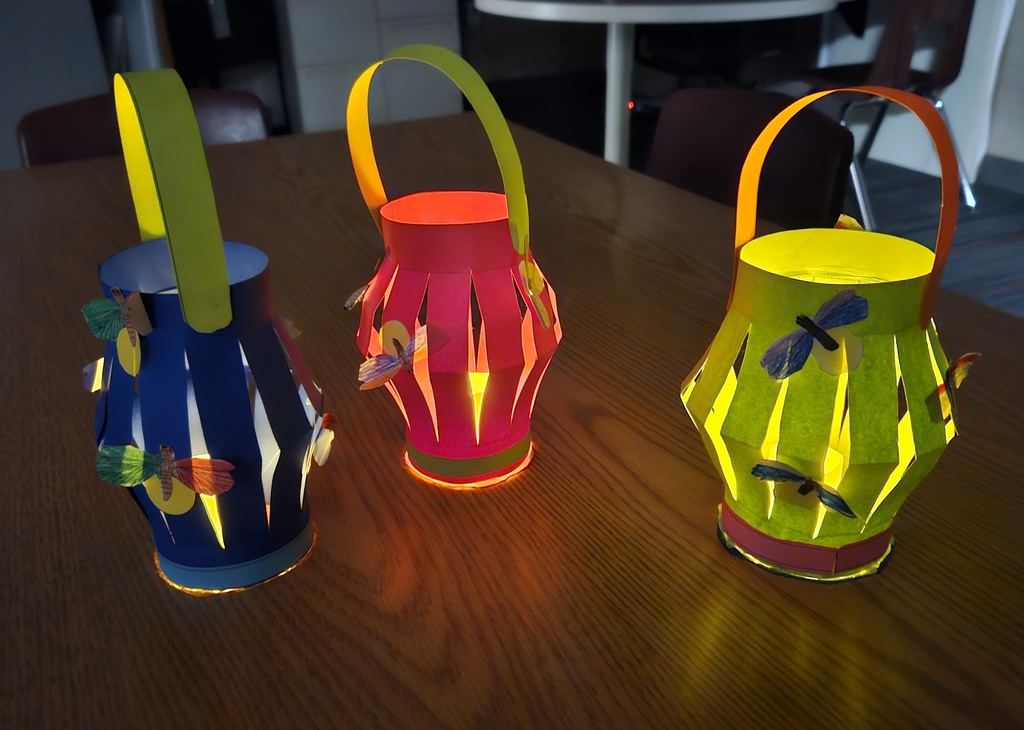 Children reading and smiling, creating reading nooks, tents and homemade lanterns