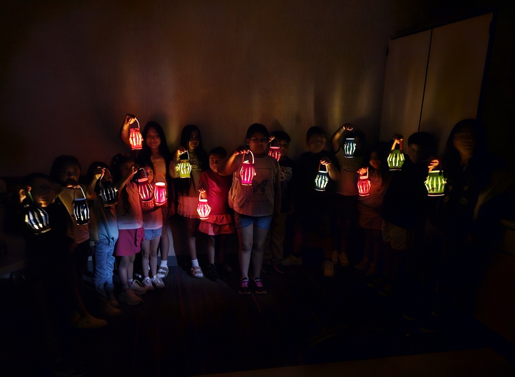 Children reading and smiling, creating reading nooks, tents and homemade lanterns