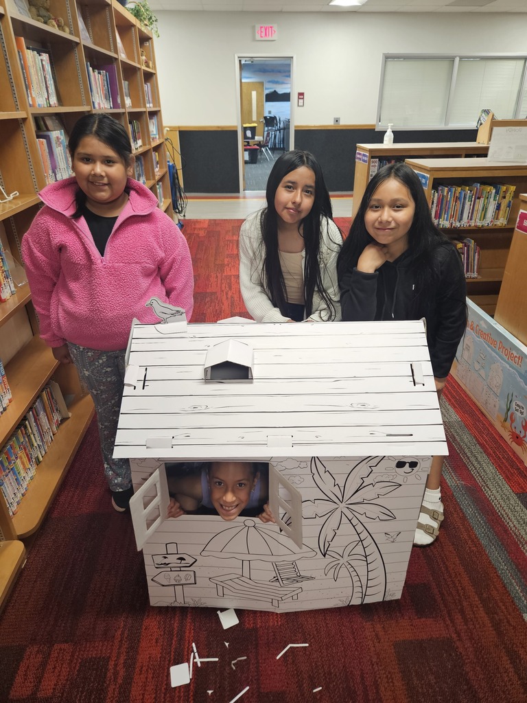Children reading and smiling, creating reading nooks, tents and homemade lanterns