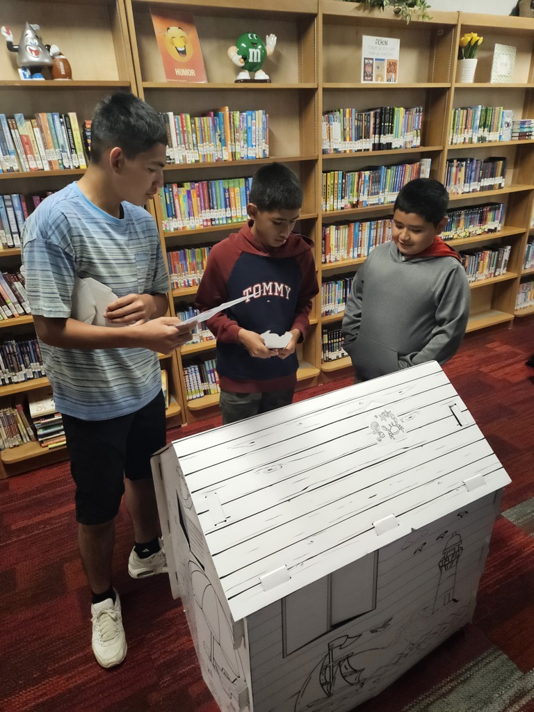 Children reading and smiling, creating reading nooks, tents and homemade lanterns