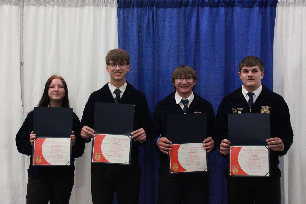 FFA students smiling at FFA State Convention in June holding State Degree Awards