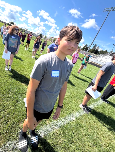 MHS Band Camp students playing instruments, practicing the halftime routine on the football field, and marching