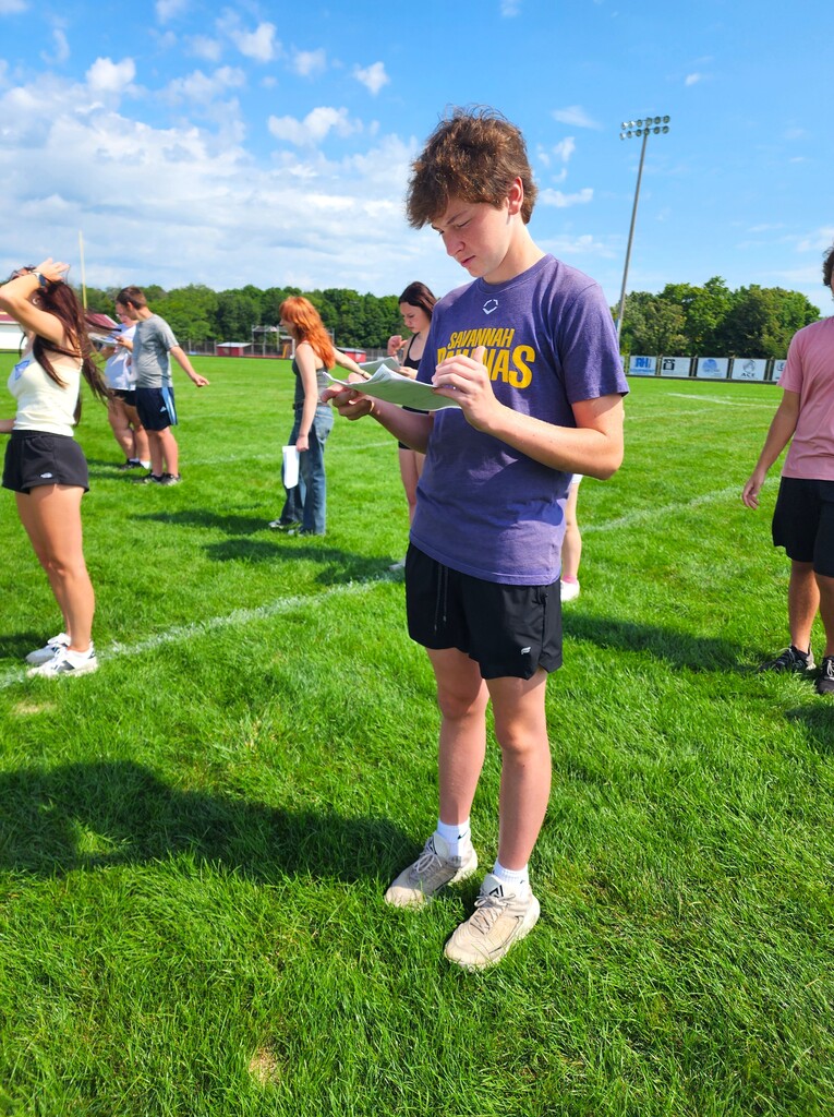 MHS Band Camp students playing instruments, practicing the halftime routine on the football field, and marching