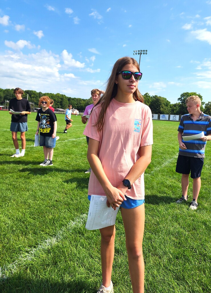 MHS Band Camp students playing instruments, practicing the halftime routine on the football field, and marching