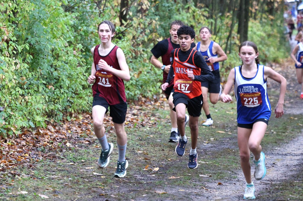 MHS Cross Country running at rainy muddy wet Conference Meet on 10/15/26