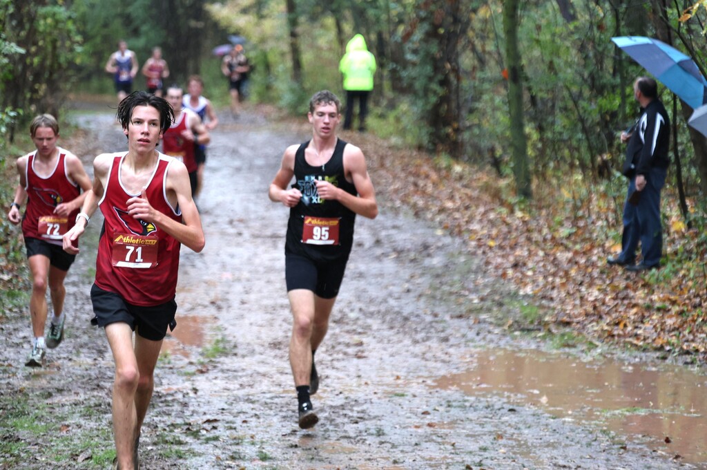 MHS Cross Country running at rainy muddy wet Conference Meet on 10/15/26