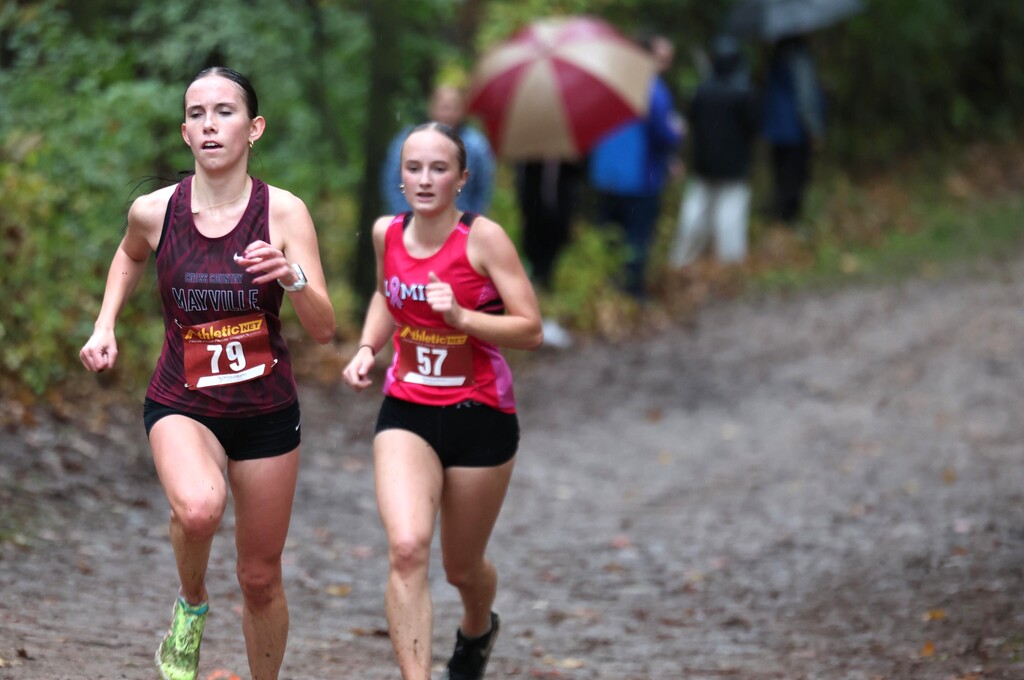 MHS Cross Country running at rainy muddy wet Conference Meet on 10/15/26