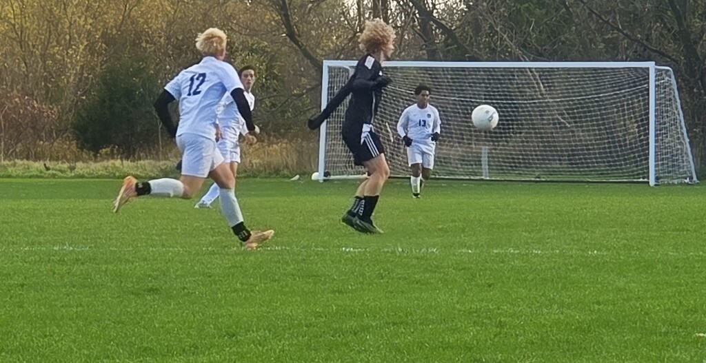 MHS Boys Soccer vs. Lake Mills at home final regular season game 10/16/26 student athletes playing on sunny soccer field with fall background