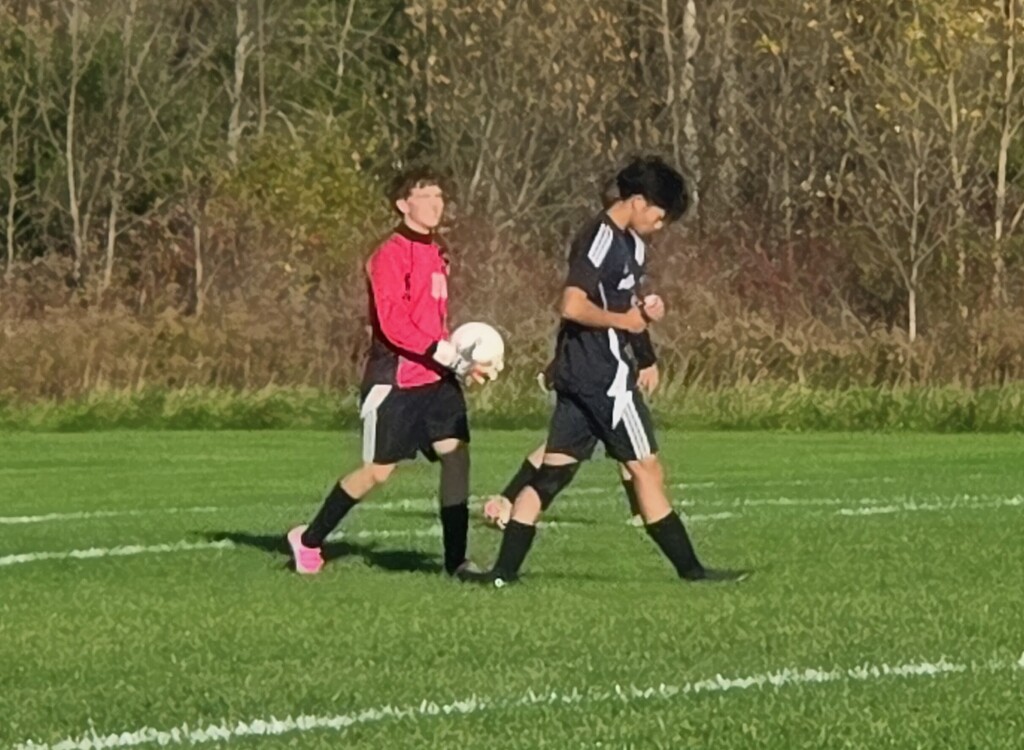 MHS Boys Soccer vs. Lake Mills at home final regular season game 10/16/26 student athletes playing on sunny soccer field with fall background