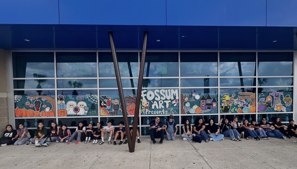 Fossum Falcon Visual Art students in front of their mural at main event. Avengers lego themed 