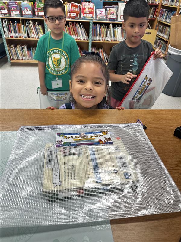 Kids posing with book pouches.