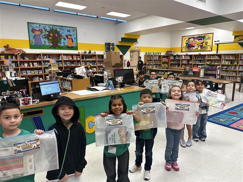 Kids posing with book pouches.