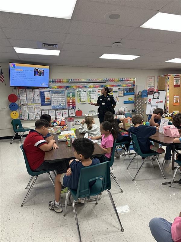 Officer presenting to students.