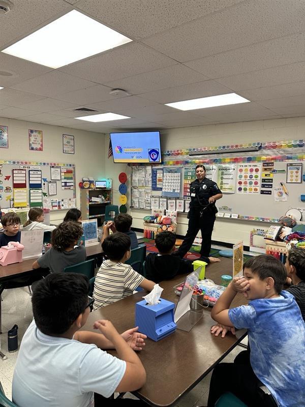 Officer presenting to students.