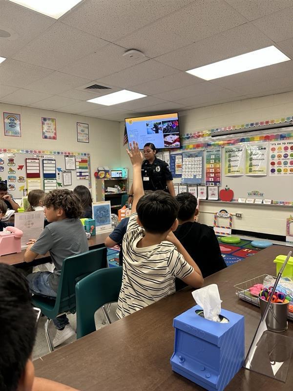 Officer presenting to students.