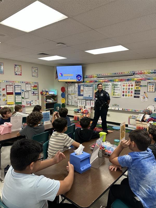 Officer presenting to students.