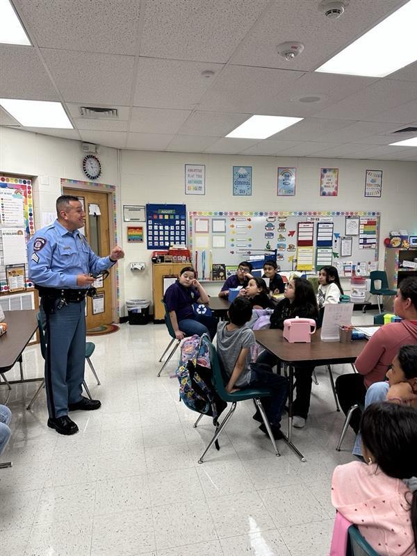 Officer presenting to students.