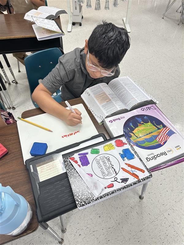 Kids working with dictionary.