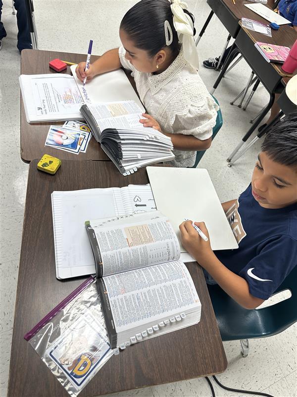 Kids working with dictionary.