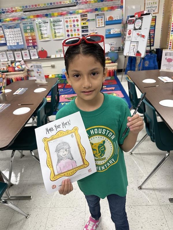 Kid posing with art activity.