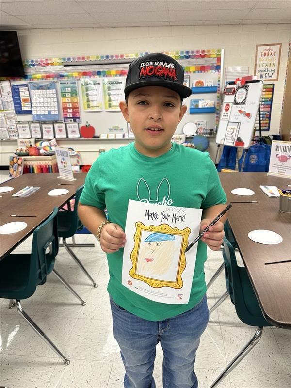 Kid posing with art activity.
