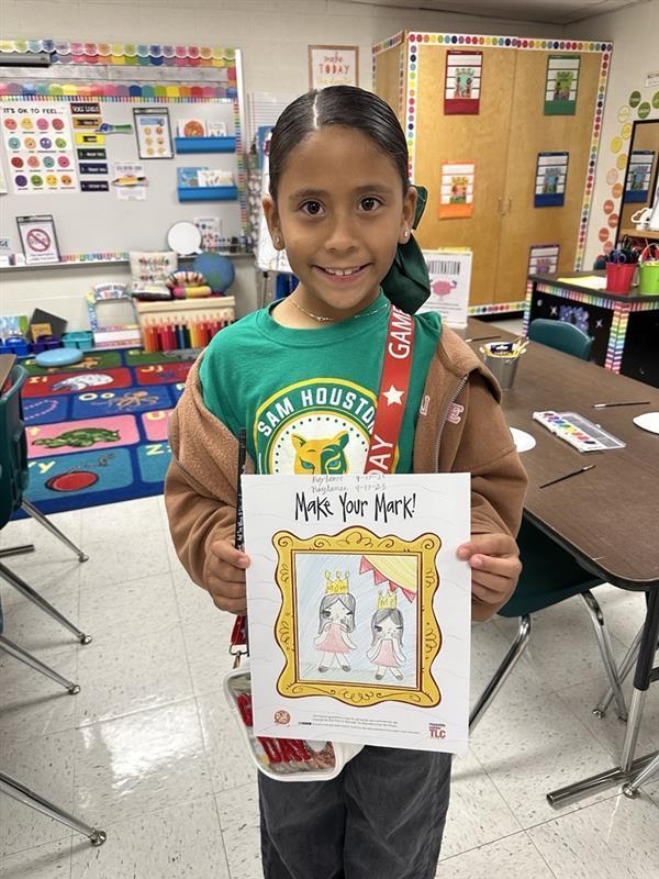 Kid posing with art activity.