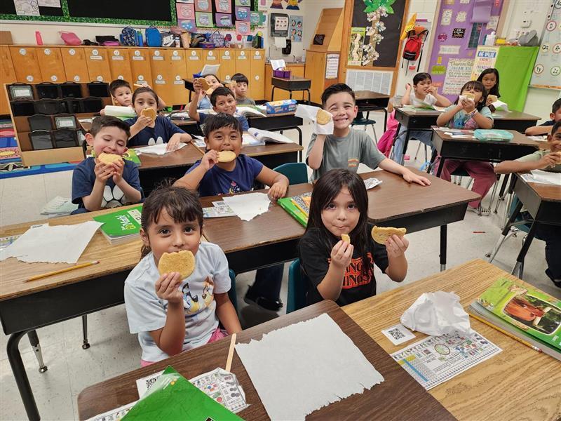Kids eating cookies.