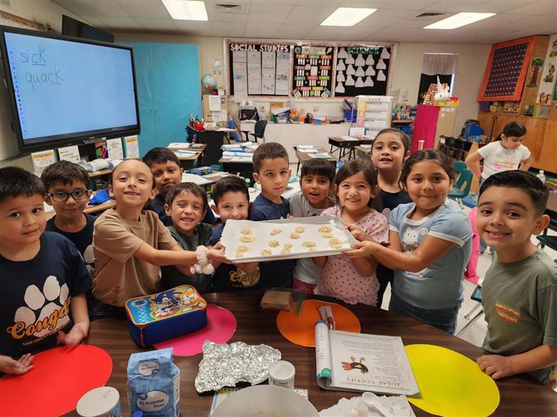 Kids posing with cookie pan.
