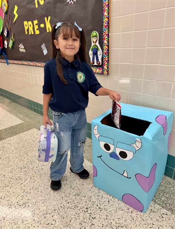 Kid posing feeding a game-themed box.