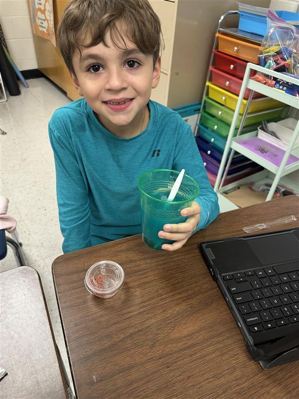 Student posing with refreshing drink.