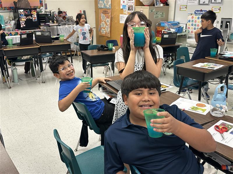 Students posing with refreshing drinks.