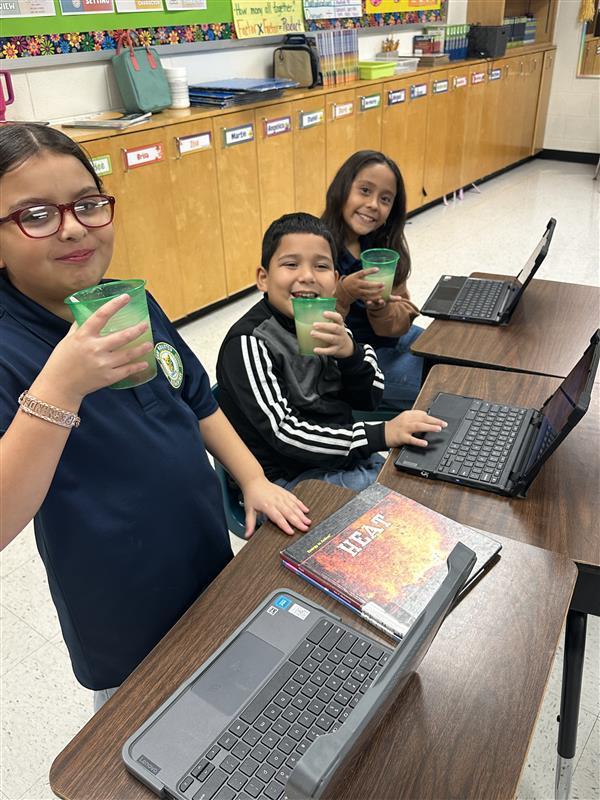 Students posing with refreshing drinks.