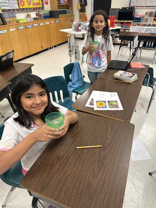 Students posing with refreshing drinks.